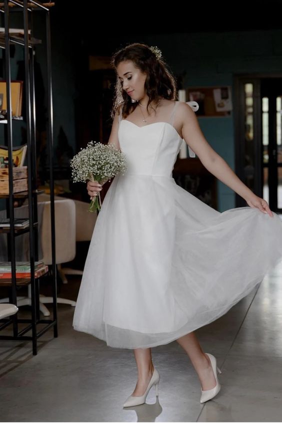 Bride in a midi tulle wedding dress with the skirt in motion
