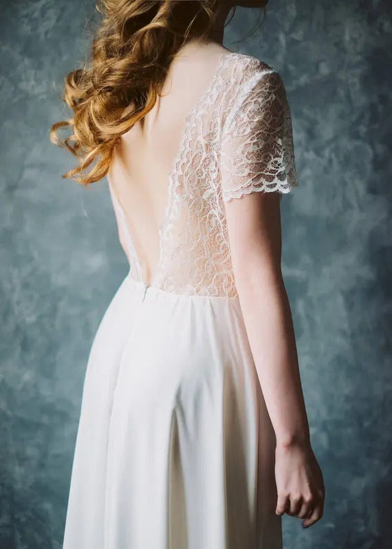 Detail of Crème Brûlée's sheer lace V-back and chiffon skirt