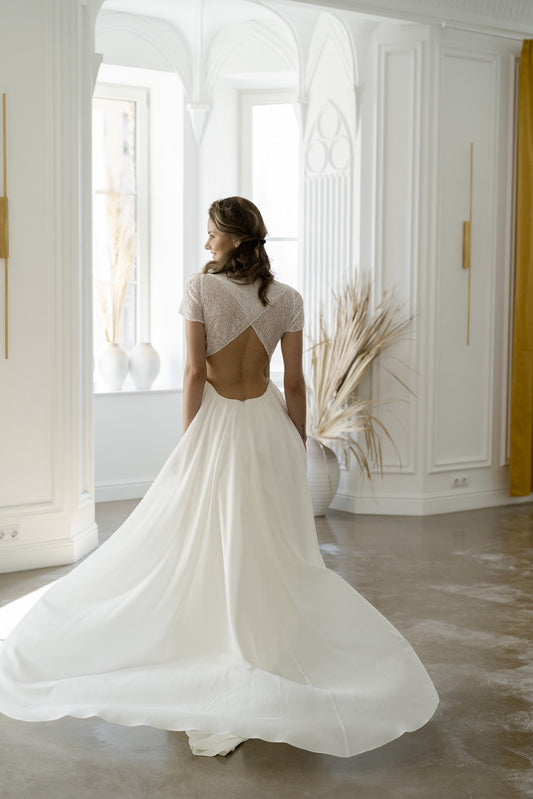 Odalis wedding dress from behind, showing the open lace back and train