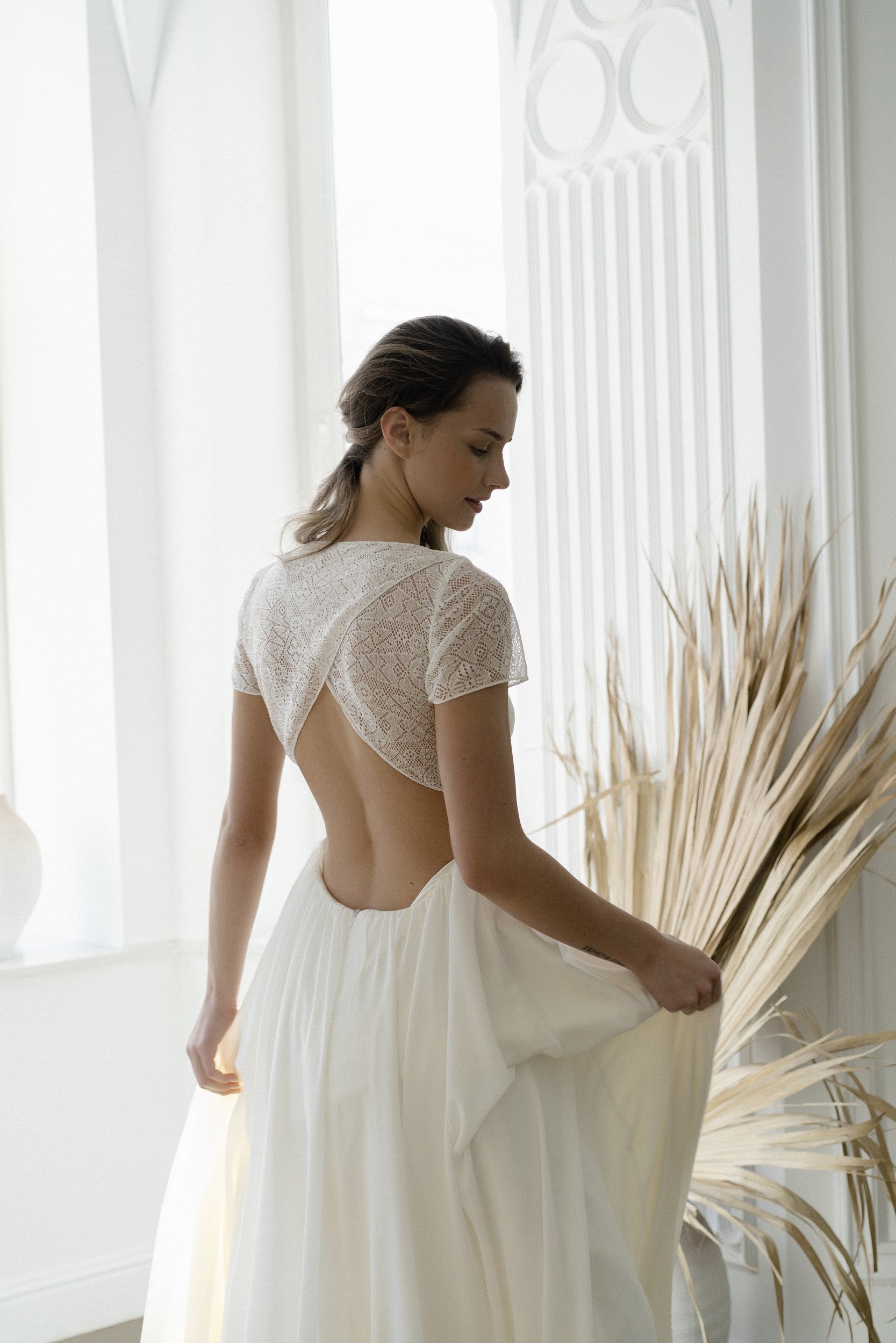 Back view of Odalis wedding dress showing crossed lace and teardrop cutout