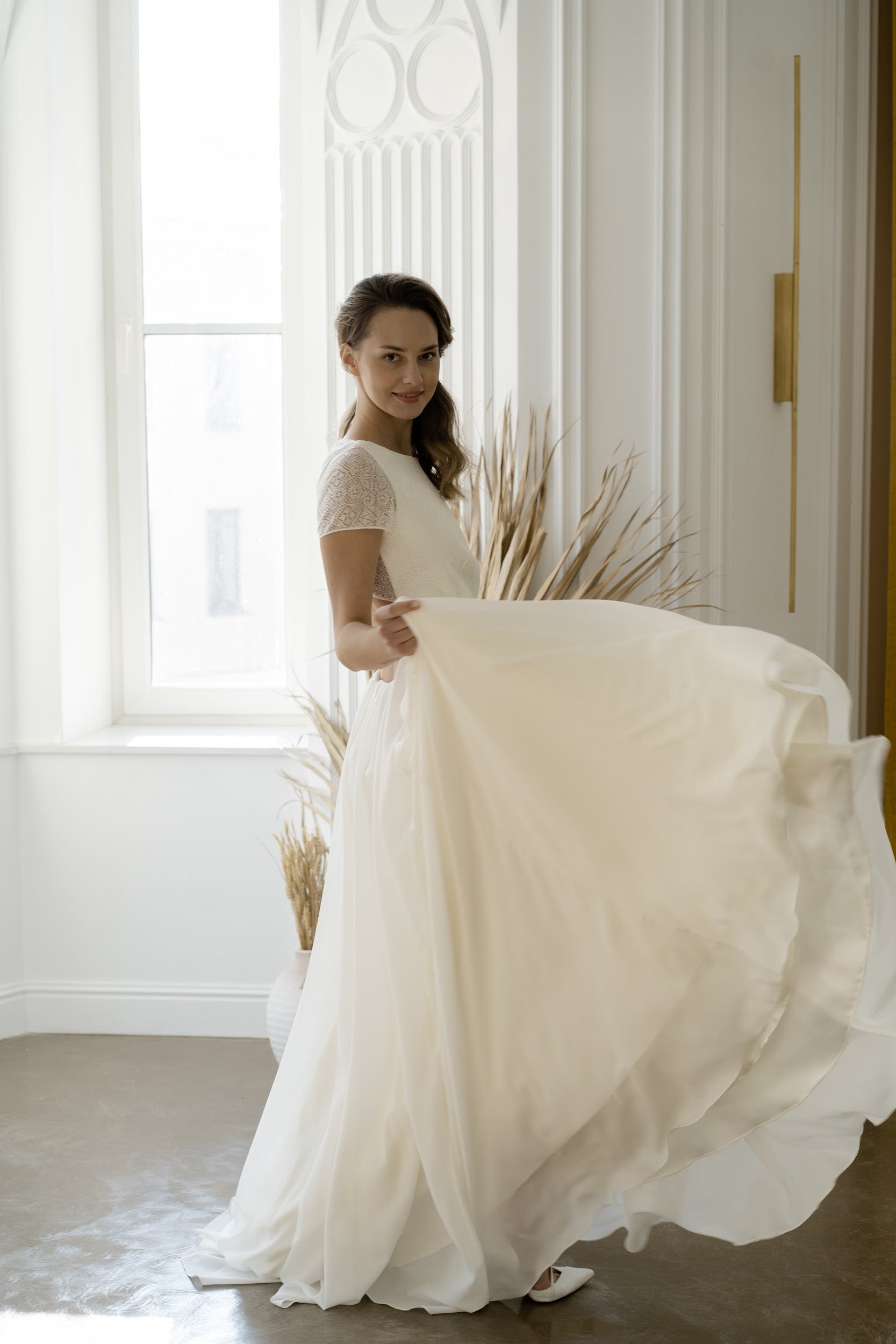 Side view of Odalis wedding dress with chiffon skirt in motion