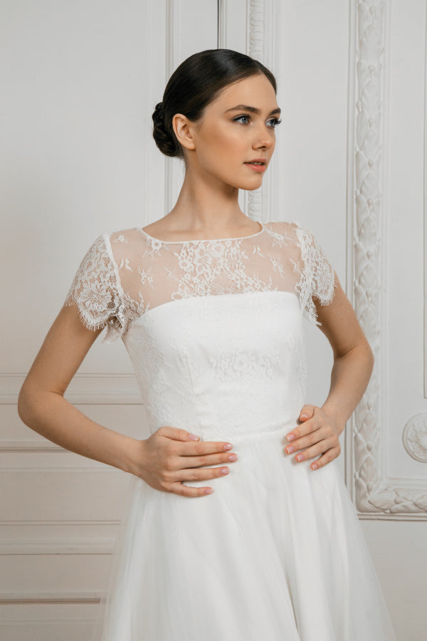 Adele wedding dress bodice detail with floral lace, illusion neckline and flutter sleeves