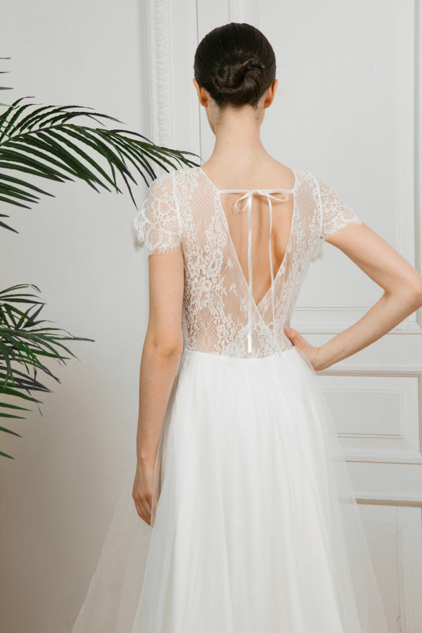Back detail of Adele wedding dress showing ribbon-tied open V back in lace