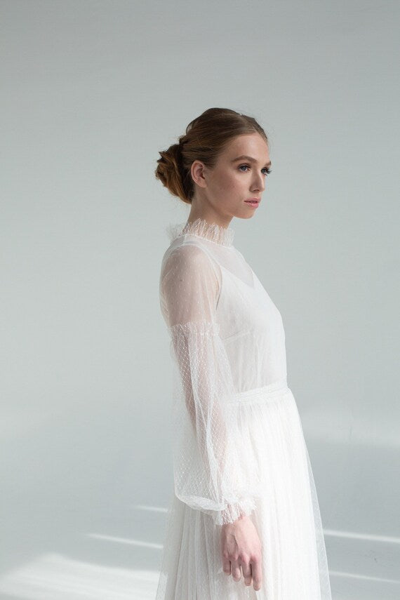 Side view of Aglaya long-sleeve tulle wedding dress showing high ruffled neckline
