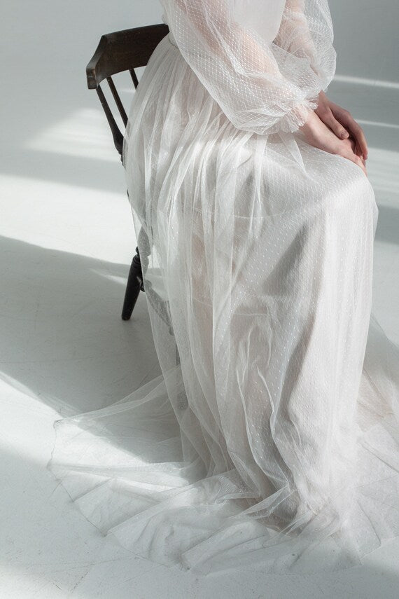 Detail of Aglaya's soft floor-length dotted-tulle skirt
