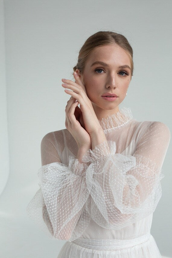 Close-up of Aglaya's full bishop sleeves and ruffled cuff in dotted tulle