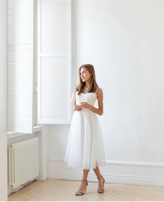 Bride in a full midi tulle wedding dress over satin, tea-length