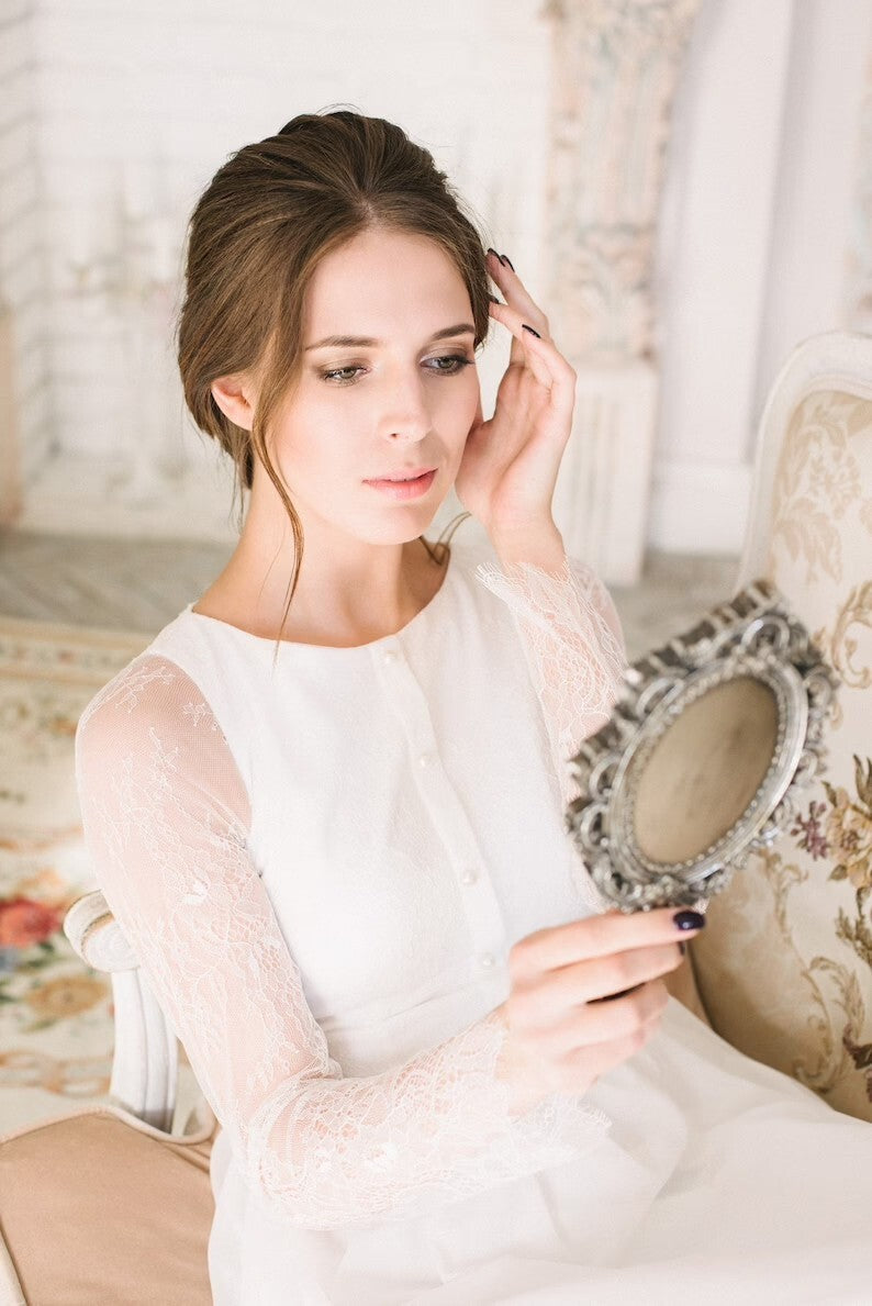 Close-up of Anna's button front placket and sheer lace sleeve
