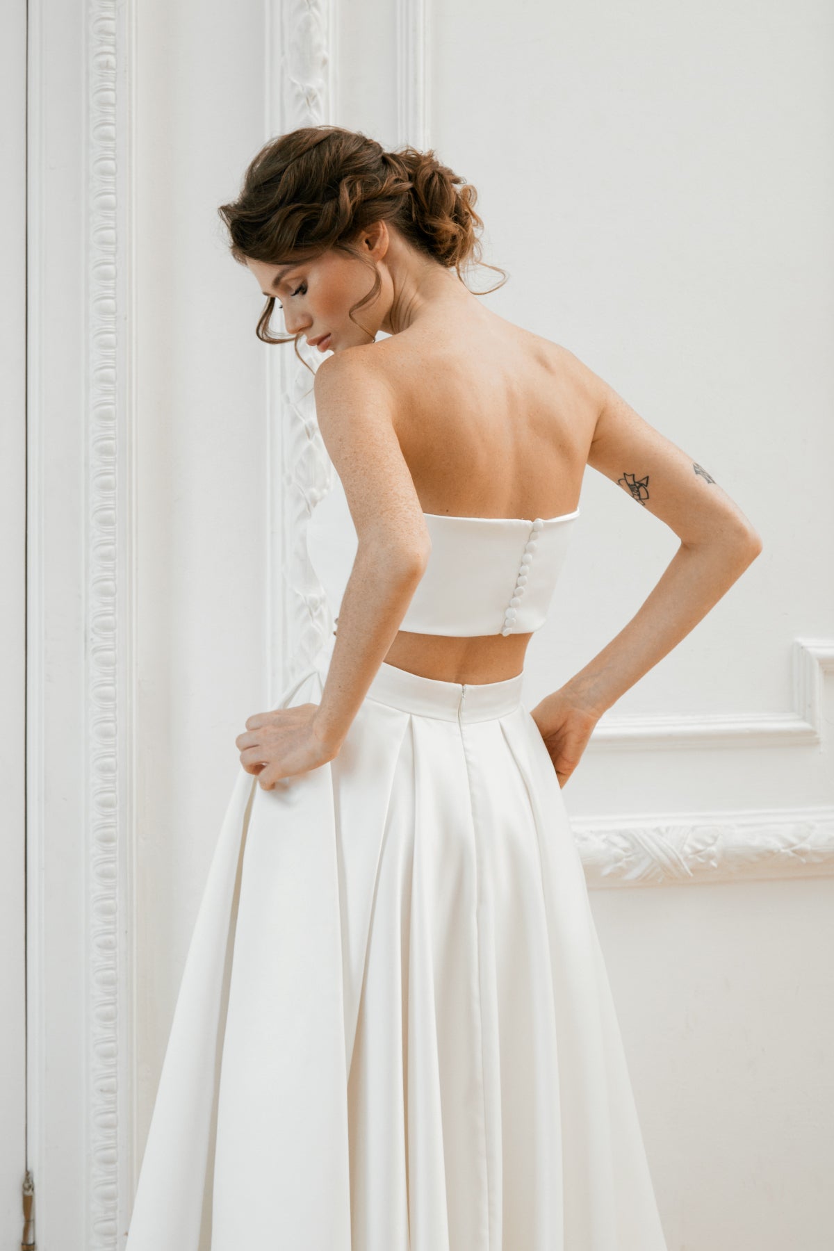 Detail of a two-piece mikado bridal set showing the crop top back and skirt pockets