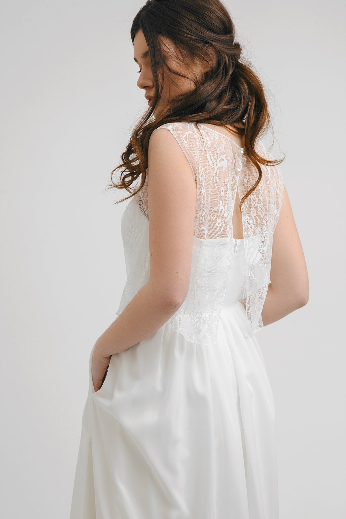 Back detail of Aurora wedding dress showing lace yoke and side pocket