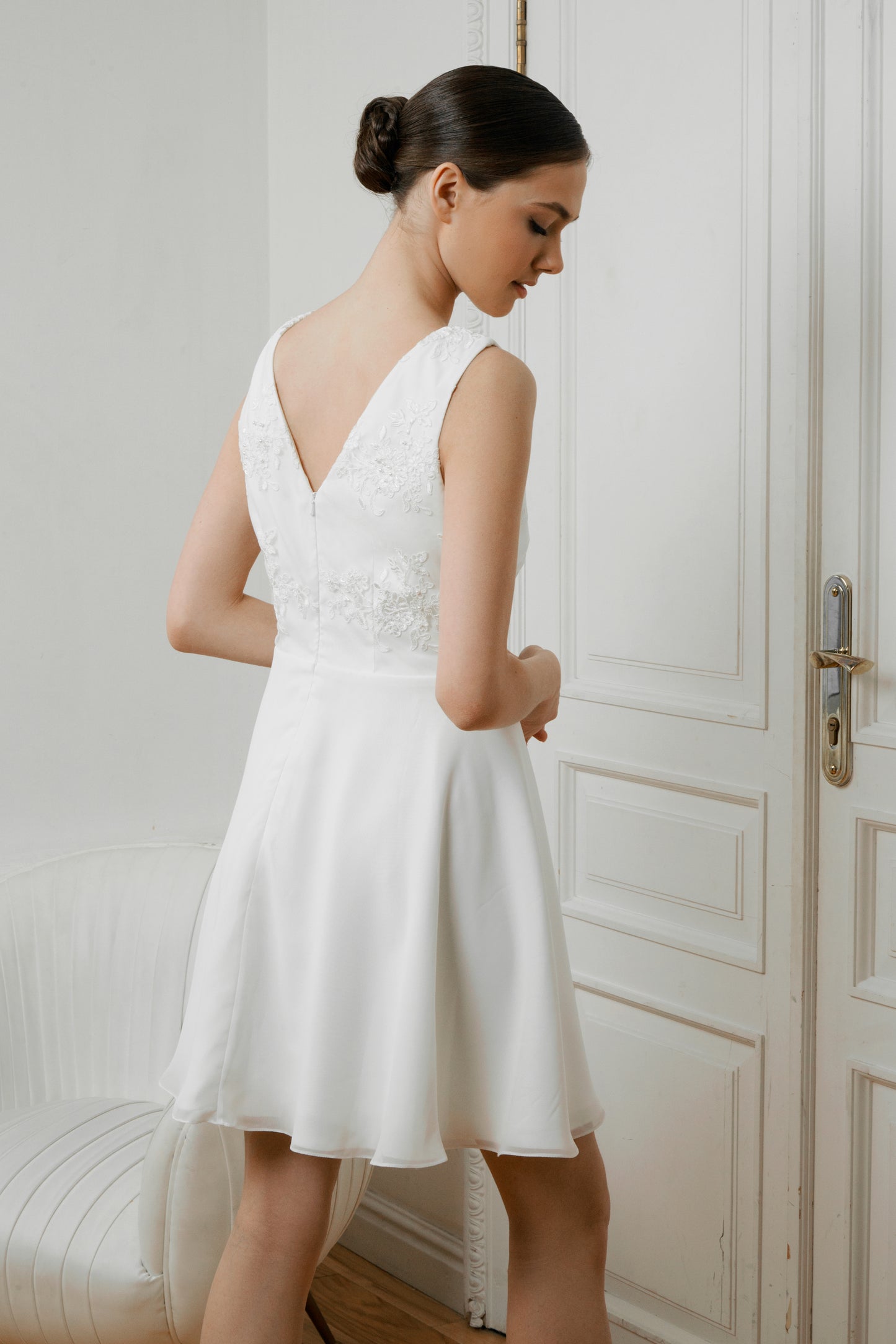 Side back view of Caroline short crepe wedding dress with lace appliqué