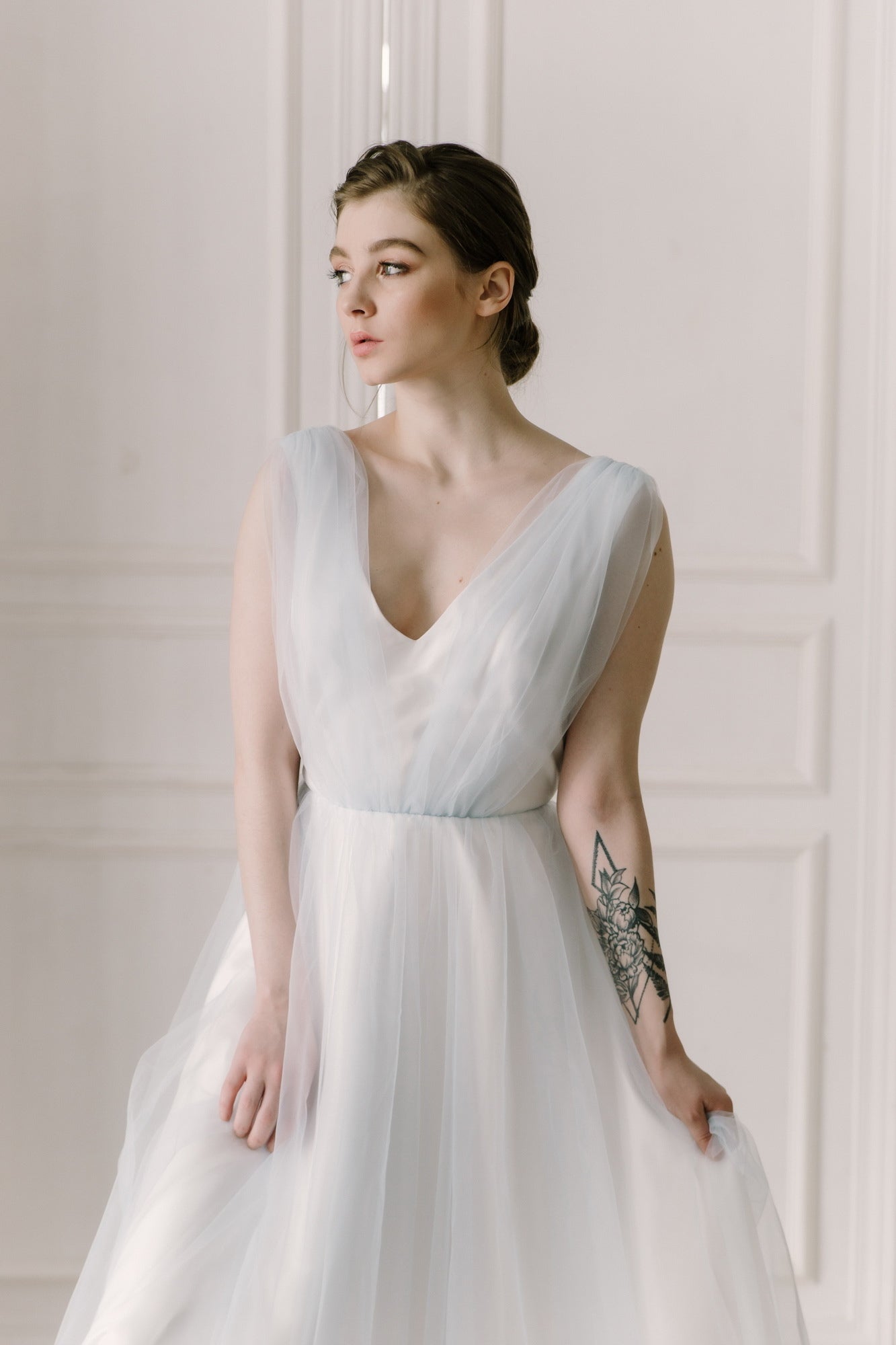 Close-up of Ciel wedding dress V-neckline in soft blue tulle