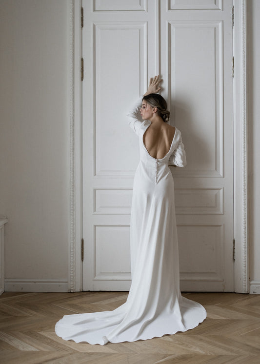 Colette open-back crepe wedding dress, back view with pearl buttons and train