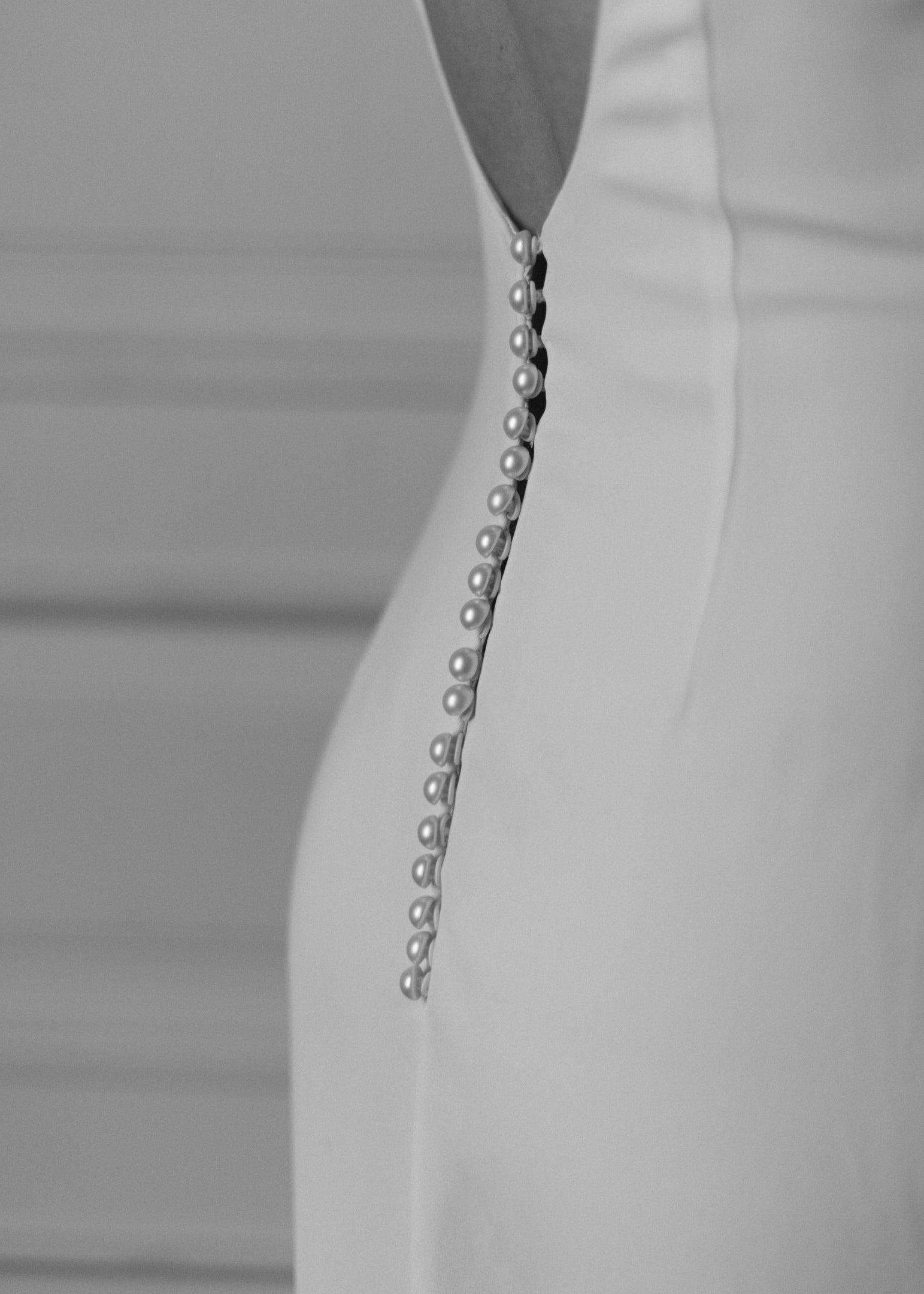 Close-up of covered pearl buttons down the back of Colette wedding dress