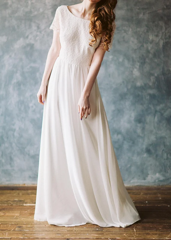 Front view of Crème Brûlée wedding dress with modest neckline and chiffon skirt