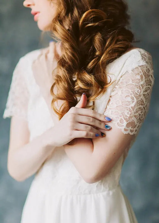 Close-up of Crème Brûlée's lace short sleeve and shoulder pattern