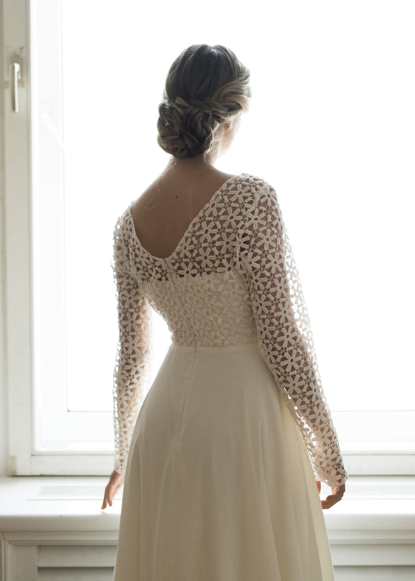 Back detail of Creme Flowers wedding dress showing open crochet lace pattern