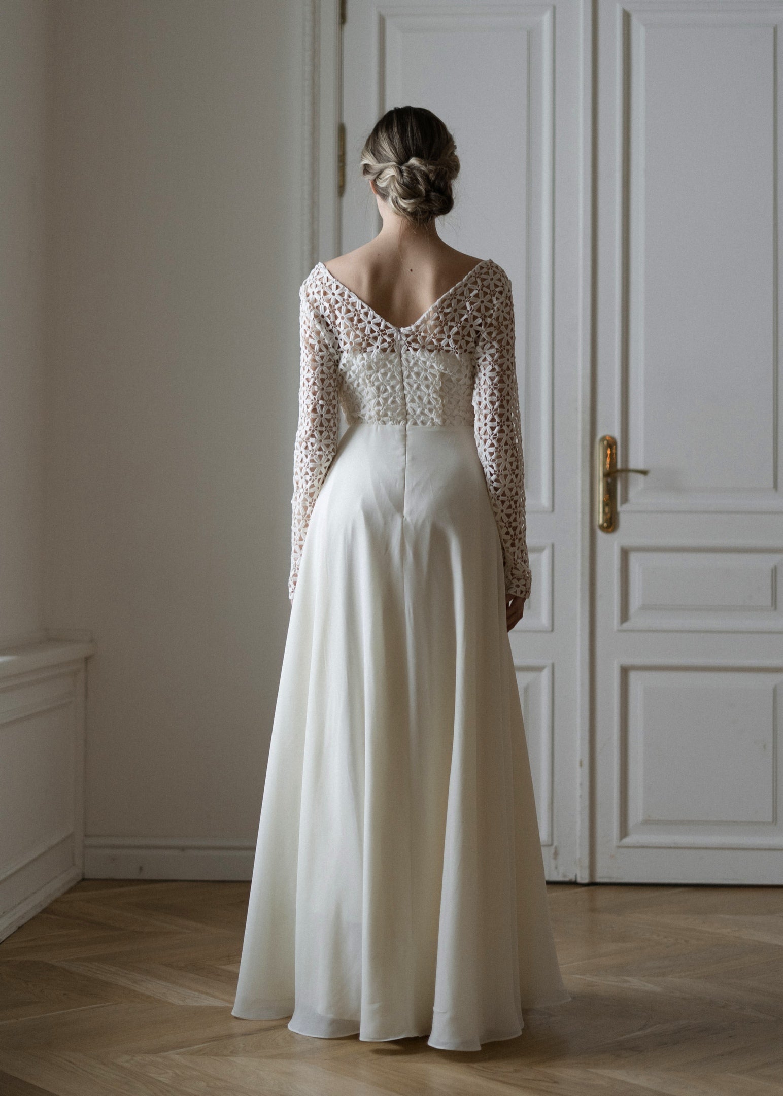 Back view of Creme Flowers wedding dress with V back and crochet lace sleeves