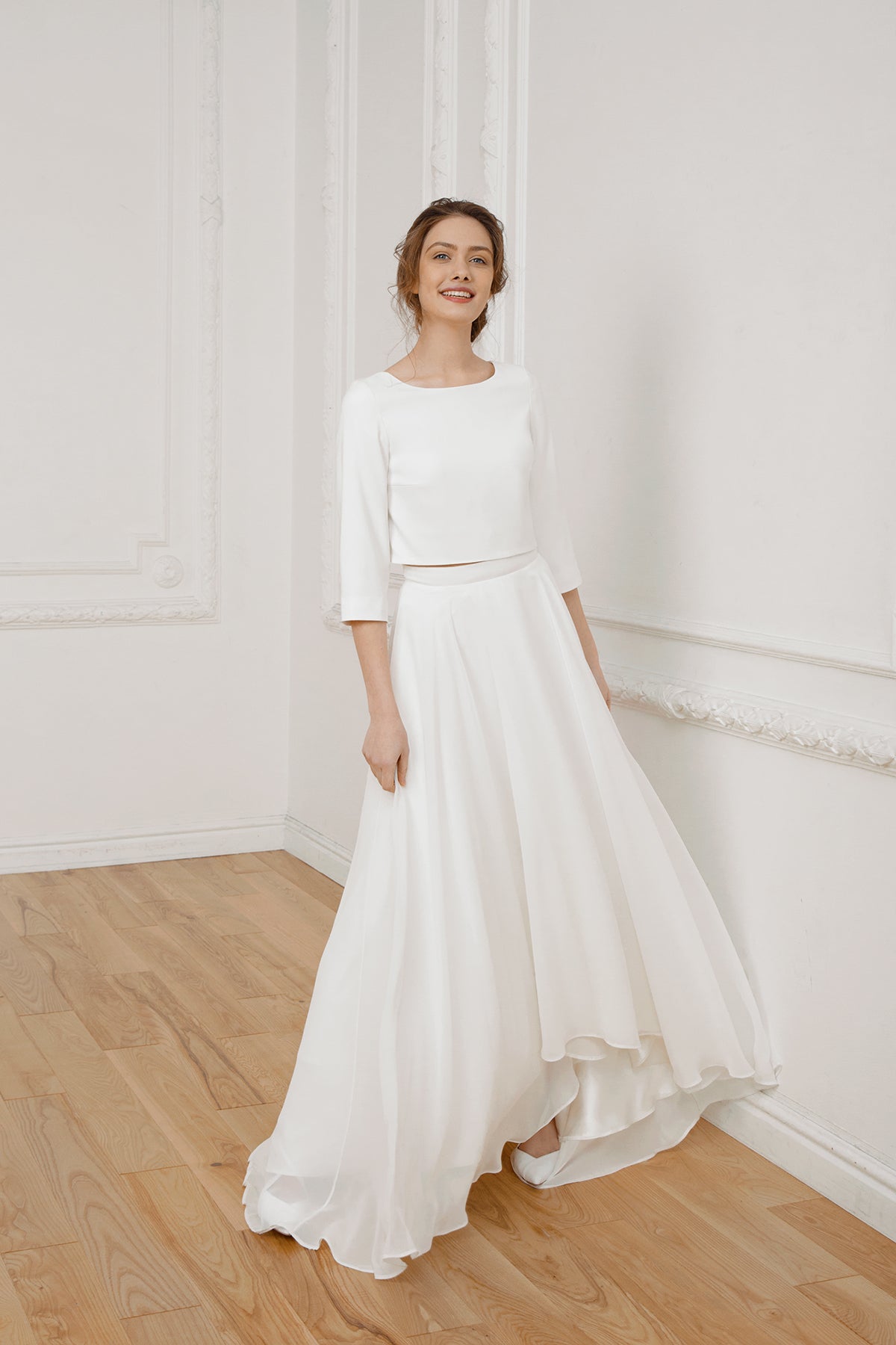 Bride in a two-piece wedding dress with a crepe crop top and high-low chiffon skirt