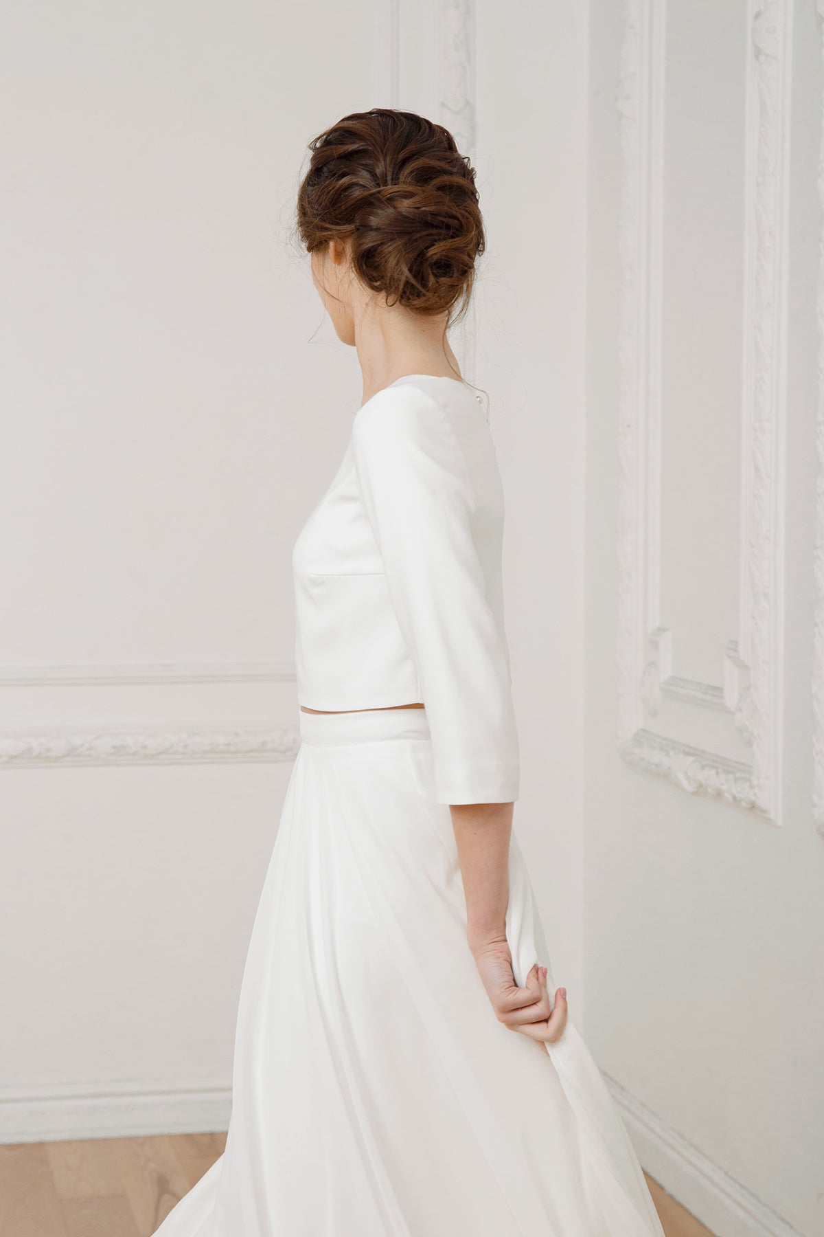 Side view of a two-piece wedding dress with a high-low chiffon skirt