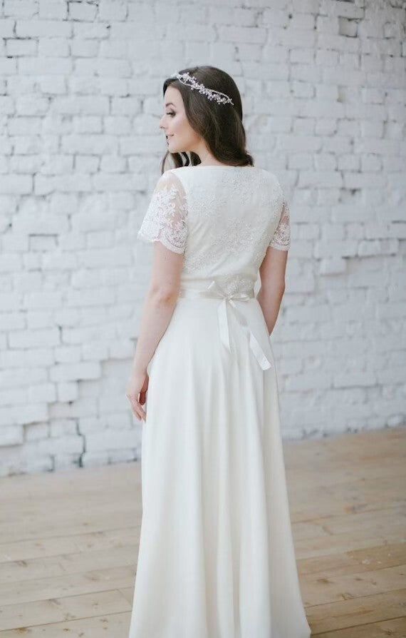 Back view of Flora wedding dress with lace bodice and ribbon tie
