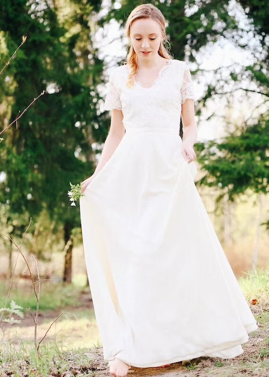 Flora wedding dress, front view — floral lace bodice and ivory chiffon skirt, outdoors
