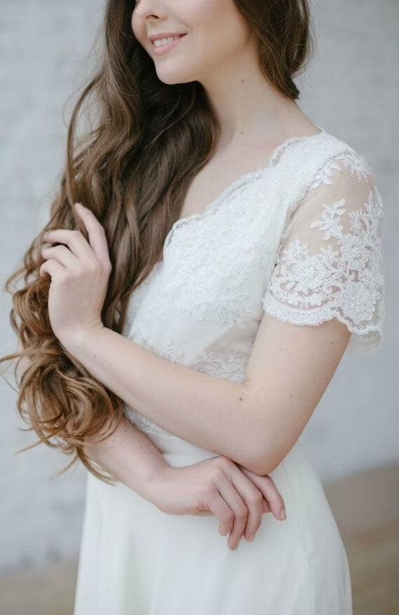 Detail of Flora's short lace sleeve and bodice