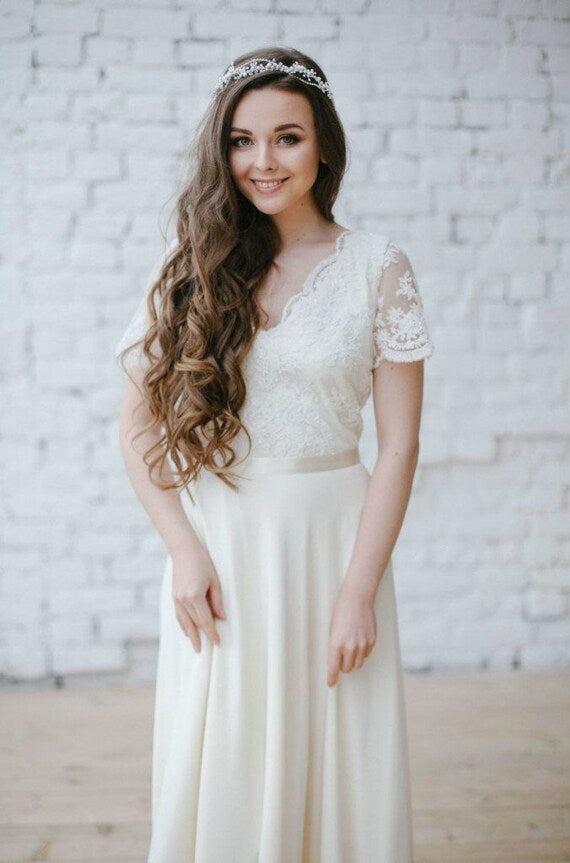 Bride in Flora floral lace wedding dress, front view smiling