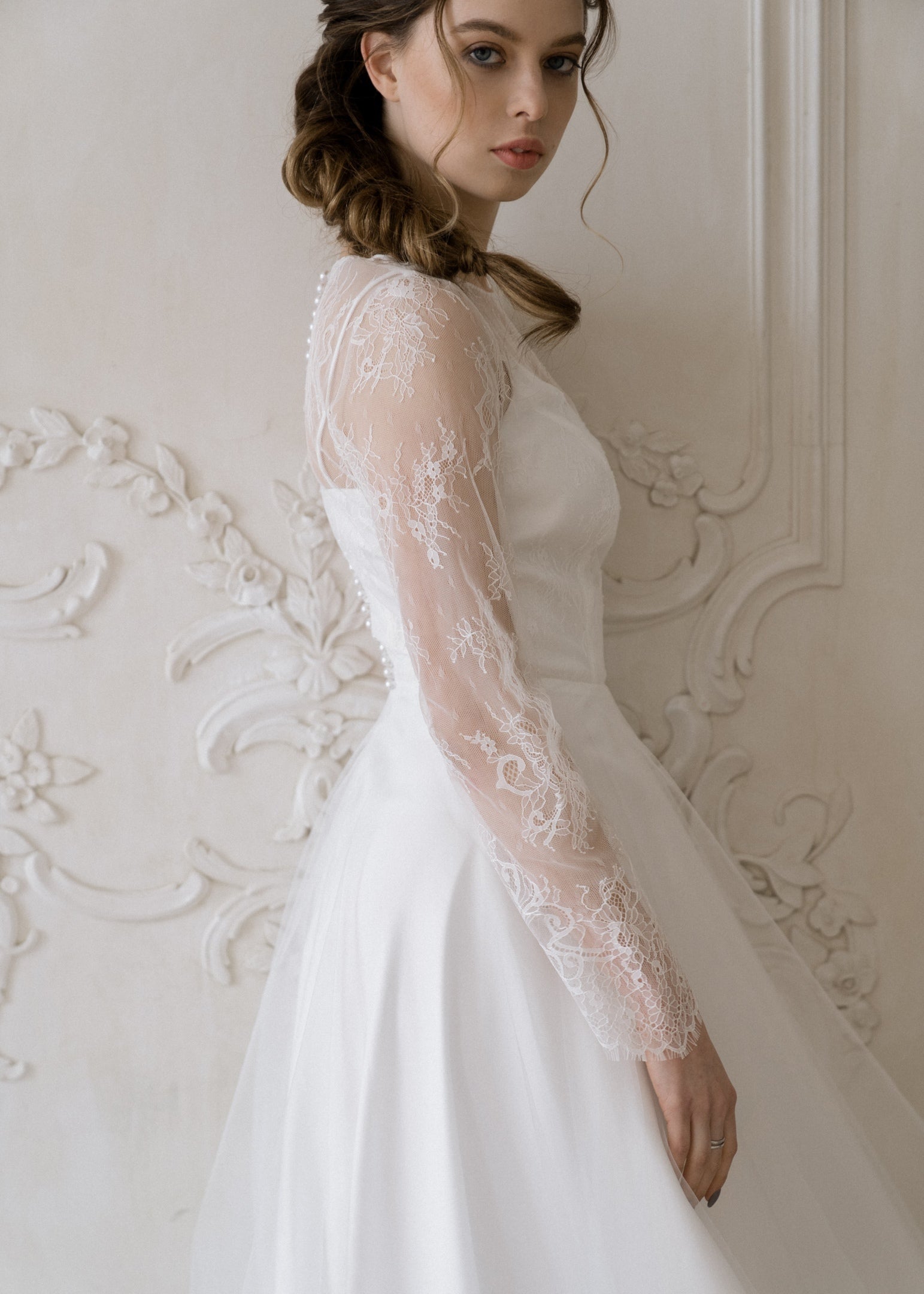Side view of Josephine lace wedding dress showing sheer lace sleeve detail
