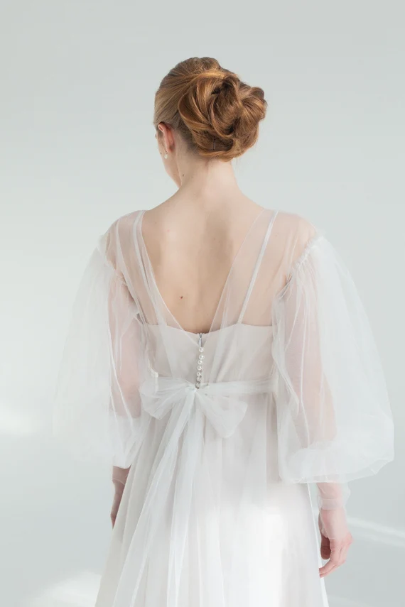 Back view of Kosmea wedding dress showing the tulle bow and pearl buttons
