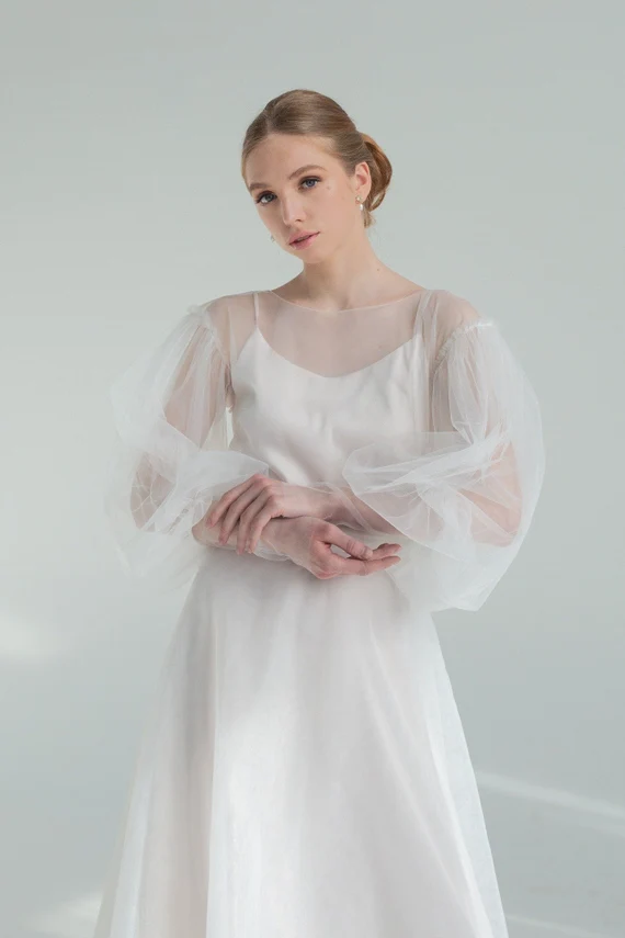 Kosmea sheer tulle wedding dress with puff sleeves over a satin slip, front view
