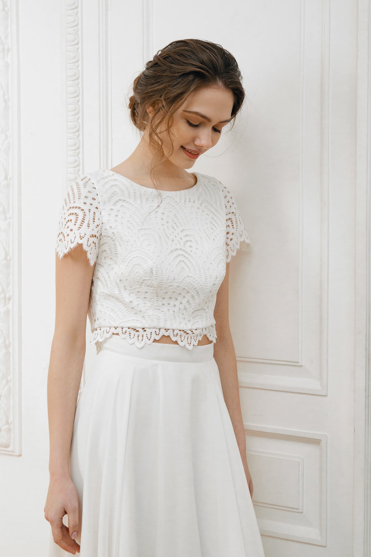 Short-sleeve lace crop top with a boat neckline and scalloped edge