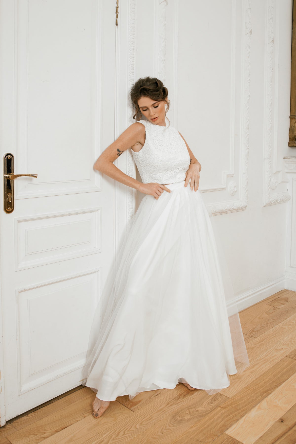 Bride in a two-piece wedding dress with a lace crop top and tulle A-line skirt