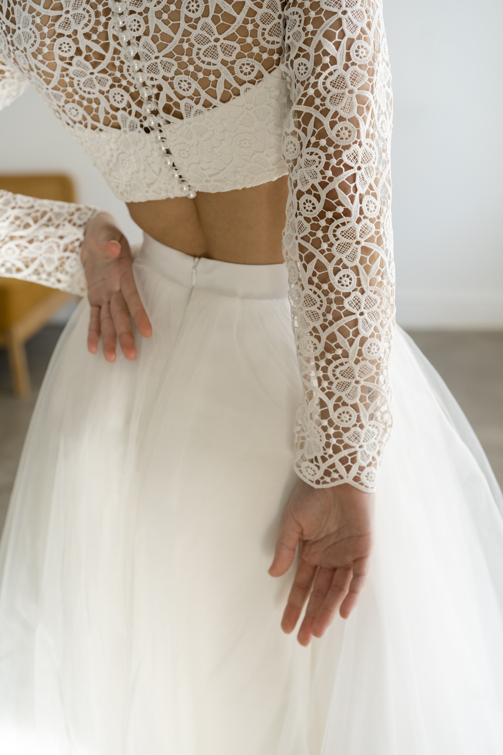 Back view of Margaux crop top with covered buttons and bare midriff above tulle skirt
