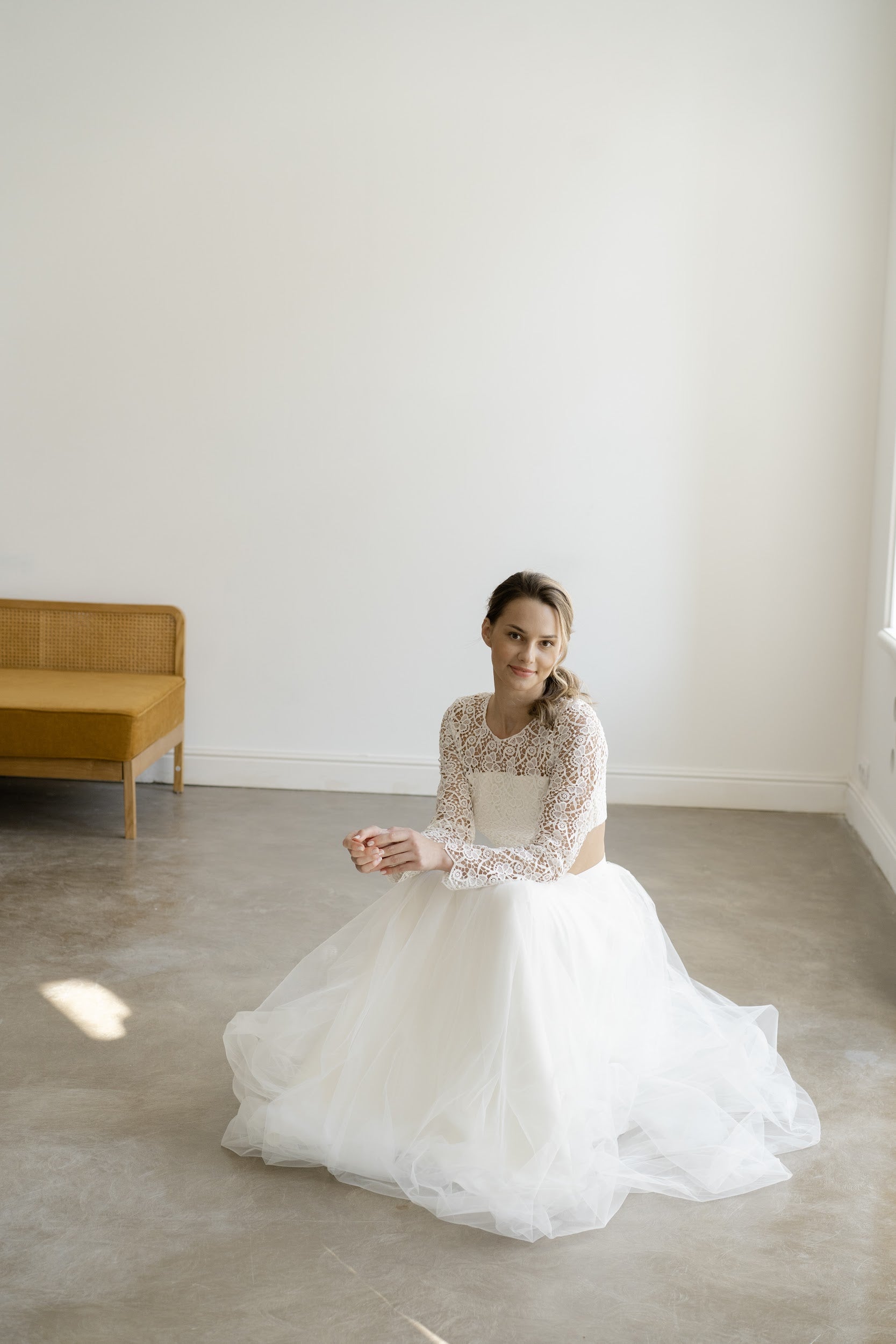 Bride seated in Margaux lace top and full tulle skirt