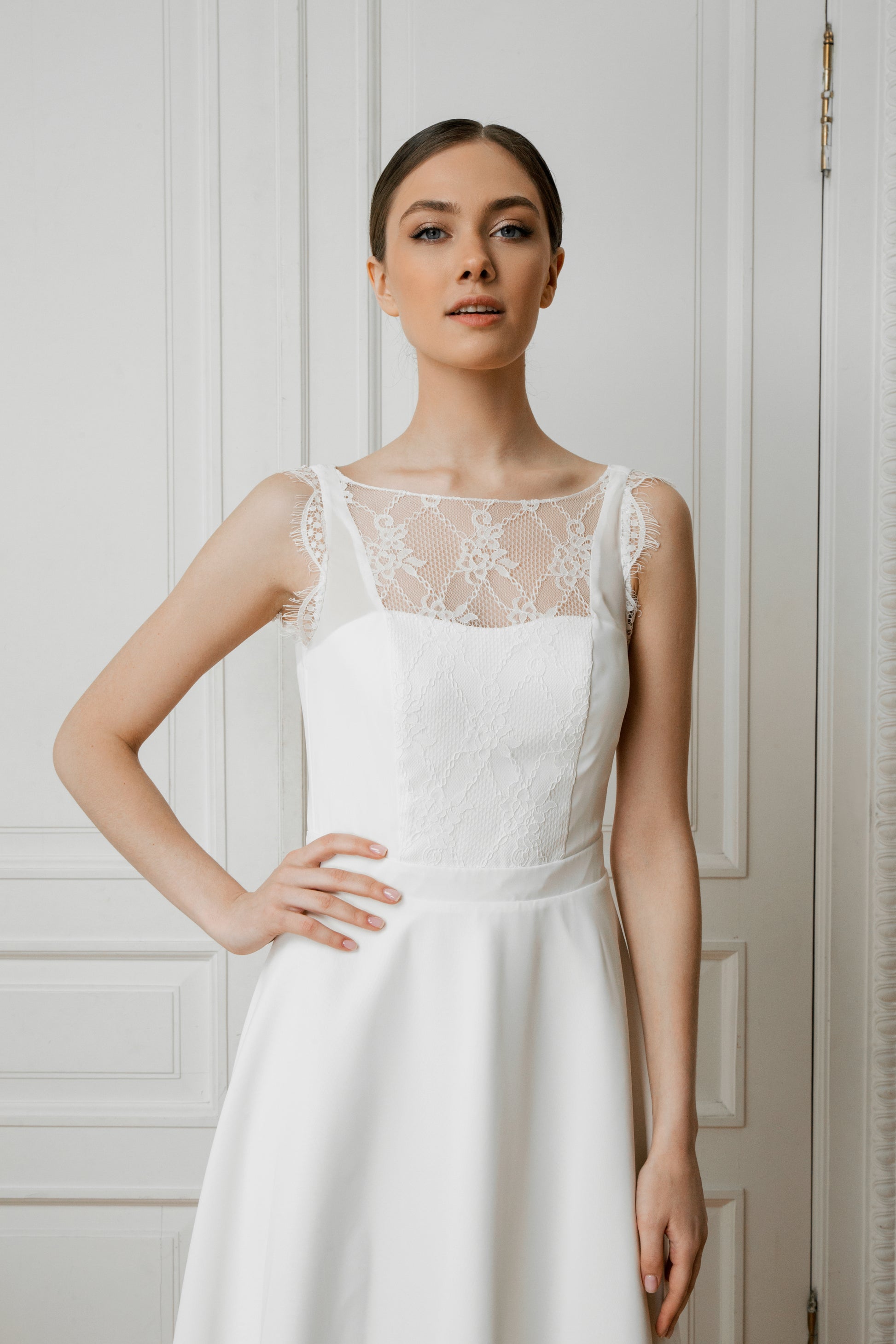 Lace illusion neckline detail on a midi crepe wedding dress