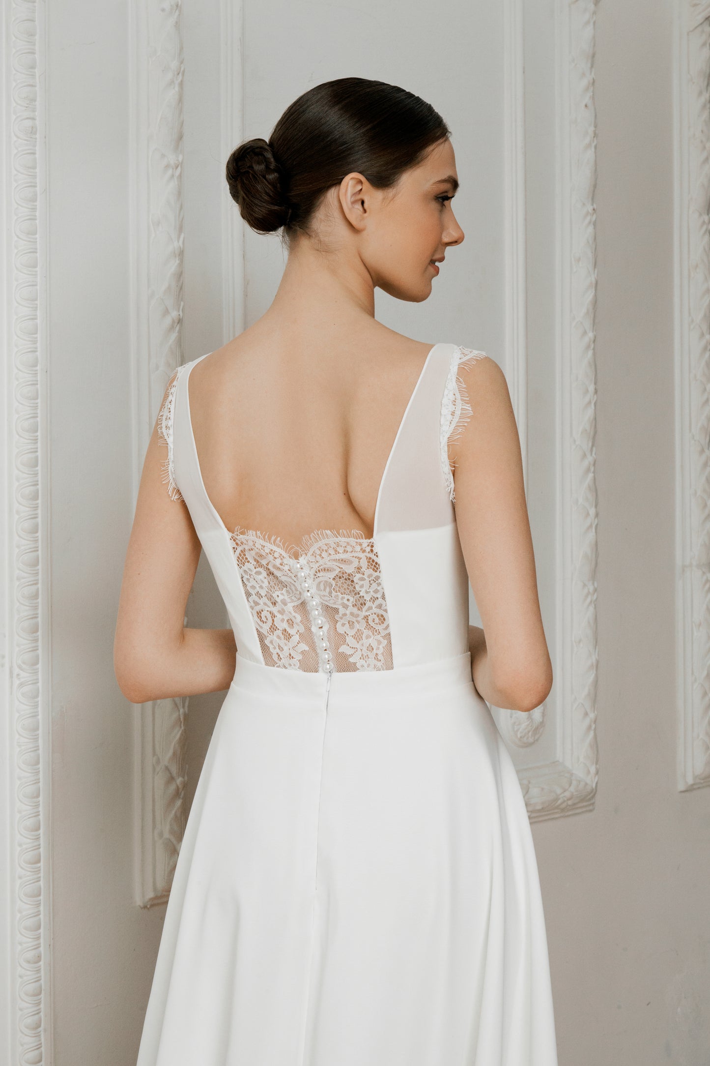 Sheer lace illusion back with covered buttons on a wedding dress