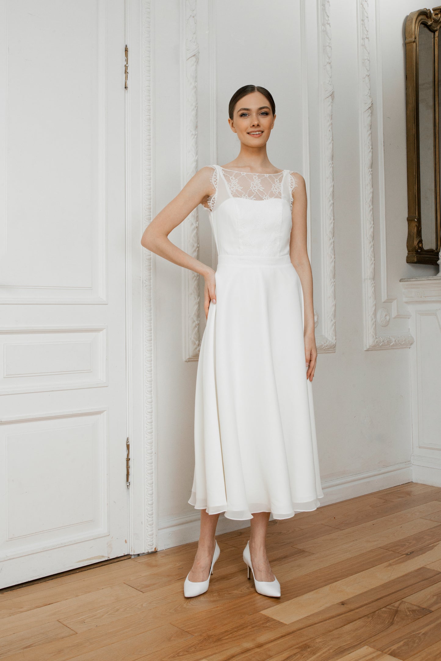 Bride in a midi royal crepe wedding dress with a lace illusion neckline and A-line skirt