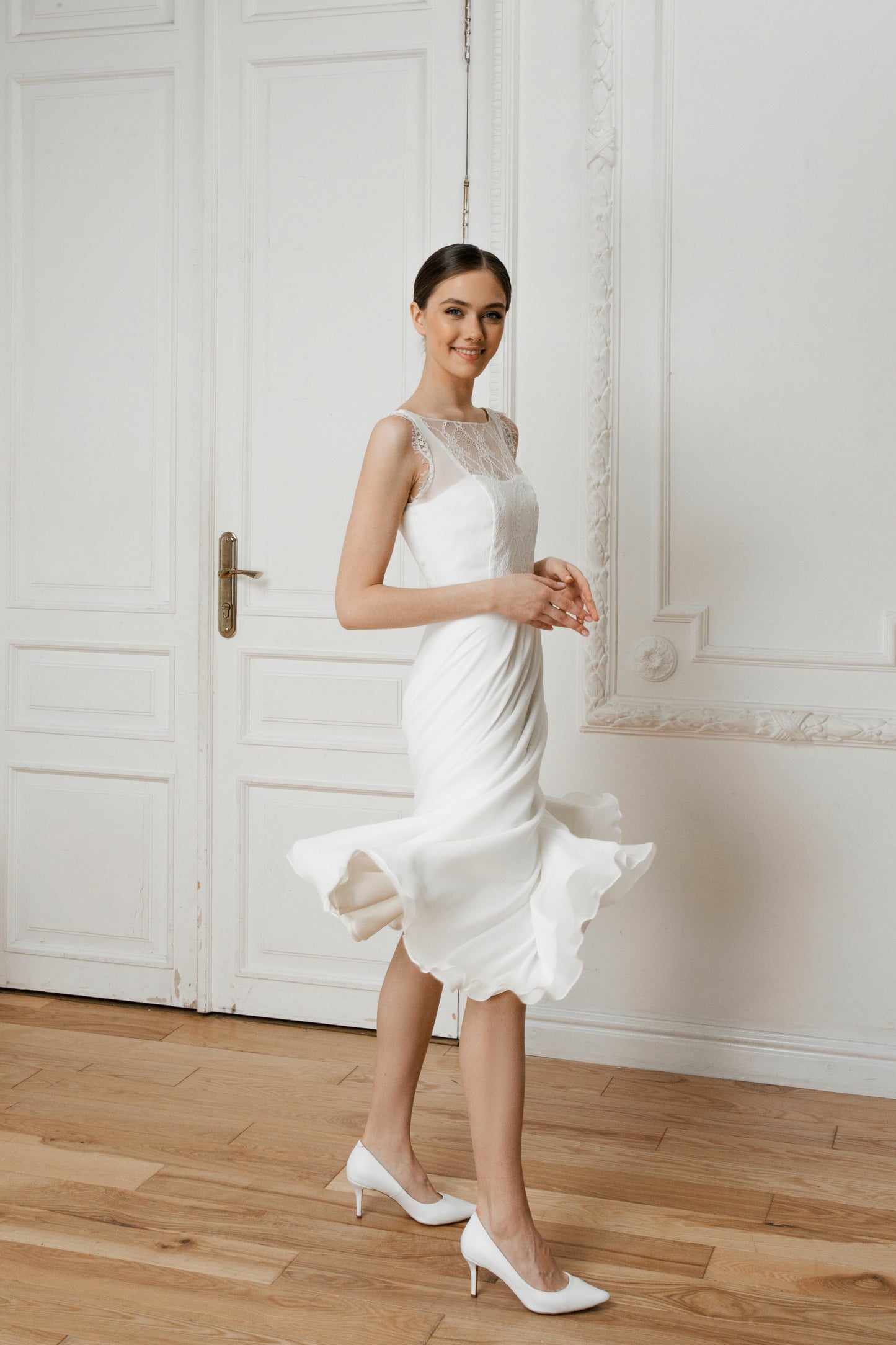 Side view of a midi wedding dress with the skirt in motion