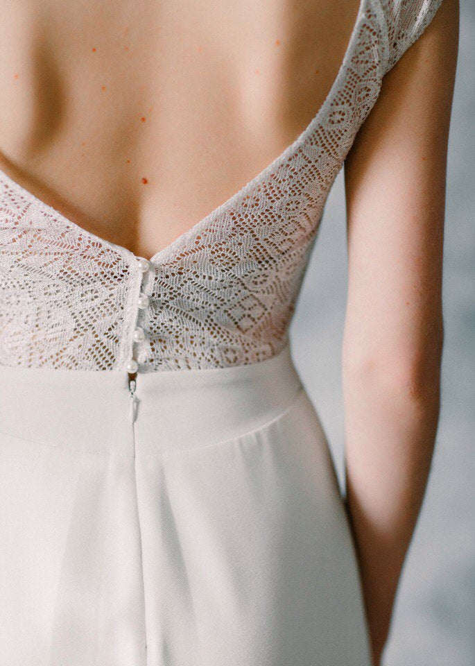 Close-up of Moonlight's low V-back with covered-button closure and vintage lace