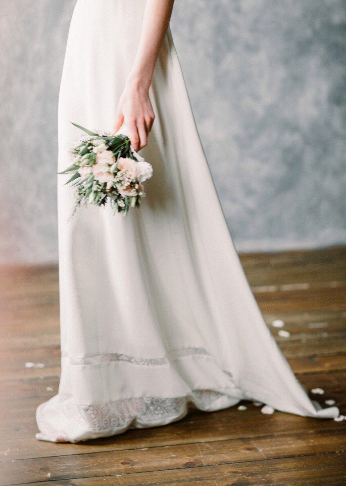 Moonlight wedding dress chiffon skirt with lace detail, held with a bouquet