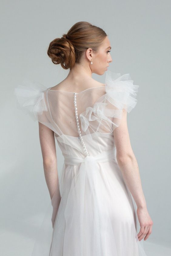 Nicole wedding dress back view with covered-button closure and tulle overlay