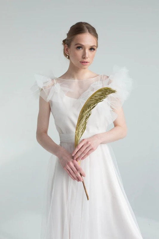 Nicole French tulle wedding dress, front view with ruffled tulle shoulders and illusion neckline