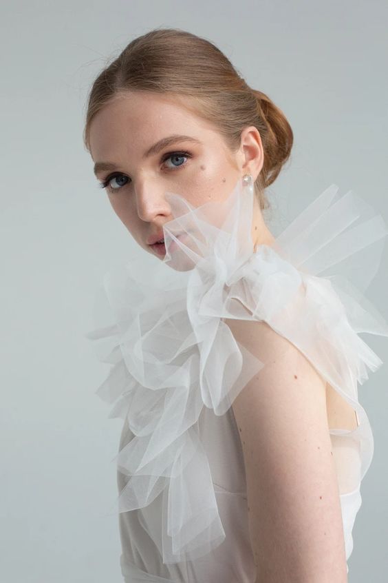 Close-up of the tulle ruffle detail on Nicole's shoulder