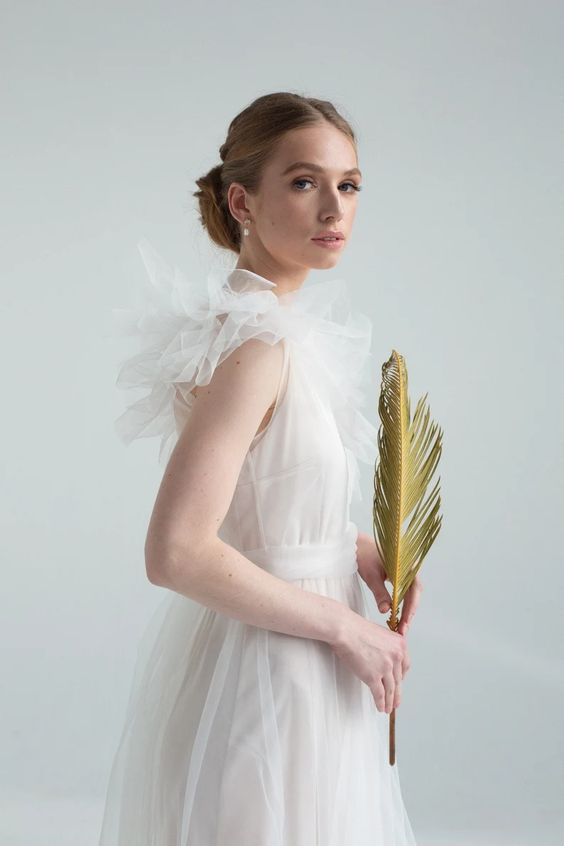 Side view of Nicole wedding dress showing gathered tulle shoulder ruffles