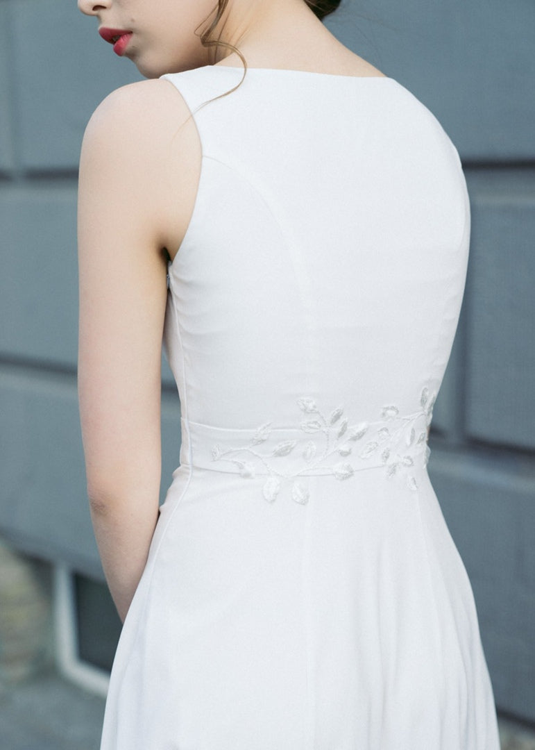 Back view of Nina wedding dress showing clean back line and embroidered belt