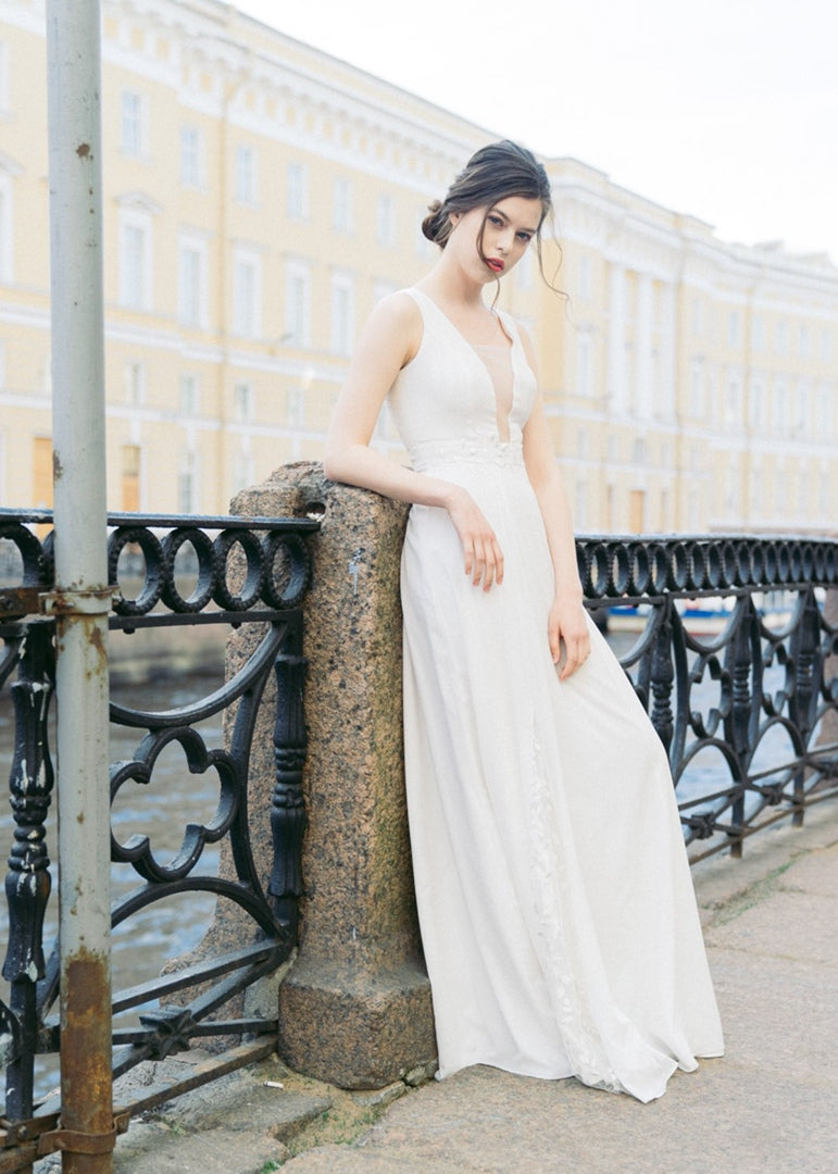 Nina wedding dress, front view in warm off-white crepe chiffon with deep V neckline