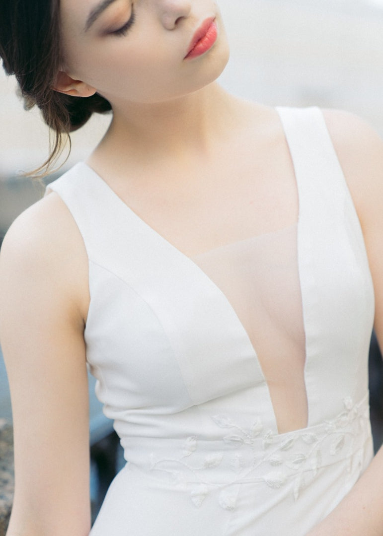 Front detail of Nina wedding dress with sheer-inset V neckline and embroidered belt