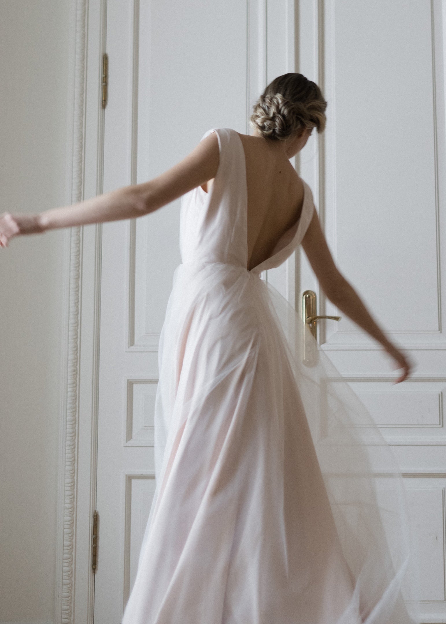 Open V-back of Peony wedding dress in soft pink tulle