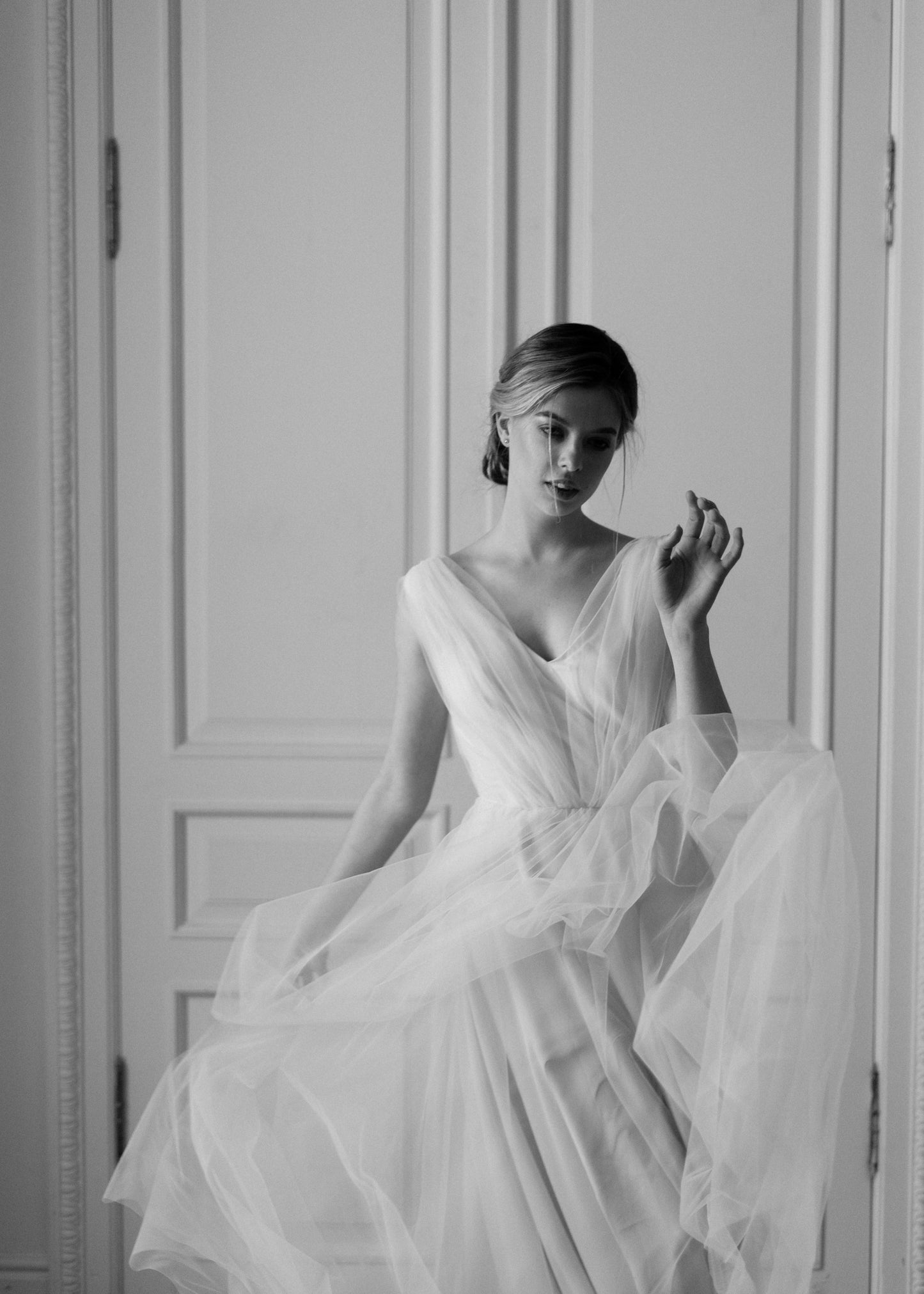 Bride seated in Peony tulle wedding dress, black and white